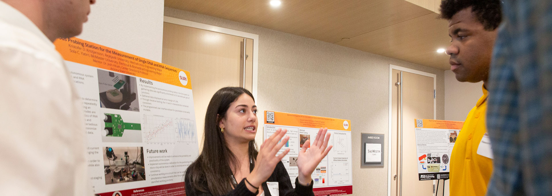 A student explaining her project to some visitors.